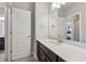 Bathroom vanity with a light countertop and view through doorway to a bedroom with bed at 214 Leland Way, Woodstock, GA 30188
