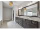 Elegant bathroom featuring a double vanity, granite countertops, and stylish lighting fixtures at 214 Leland Way, Woodstock, GA 30188