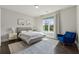 Bright bedroom features a large window, neutral walls, and a queen-size bed with stylish bedding at 214 Leland Way, Woodstock, GA 30188