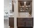 Butler's pantry featuring dark wood cabinetry, granite countertops, and subway tile backsplash at 214 Leland Way, Woodstock, GA 30188