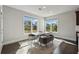Bright dining area featuring large windows offering natural light and hardwood flooring at 214 Leland Way, Woodstock, GA 30188