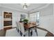 Dining room features neutral walls, an elegant light fixture, and a full table seating six at 214 Leland Way, Woodstock, GA 30188