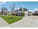 Spacious home with a long driveway, three-car garage, green lawn, and basketball hoop at 214 Leland Way, Woodstock, GA 30188