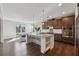 Modern kitchen with stainless steel appliances, granite countertops, and large center island with seating at 214 Leland Way, Woodstock, GA 30188