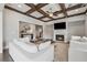 Elegant living room with coffered ceiling, fireplace, and comfortable white couches at 214 Leland Way, Woodstock, GA 30188