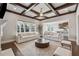 Spacious living room with coffered ceiling, hardwood floors, and abundant natural light at 214 Leland Way, Woodstock, GA 30188