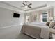 Spacious main bedroom with tray ceiling, large windows, and contemporary decor at 214 Leland Way, Woodstock, GA 30188