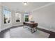 Bright and airy office space with hardwood floors, three large windows, and modern desk at 214 Leland Way, Woodstock, GA 30188