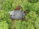 Aerial view of a home with a well-maintained roof surrounded by mature trees at 402 Chattahoochee St, Roswell, GA 30075