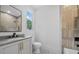 Neutral tones give this bathroom a spa-like feel with a glass shower and tiled walls at 402 Chattahoochee St, Roswell, GA 30075