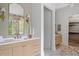 Bright bathroom featuring dual vanities, luxury finishes, and access to a walk-in closet at 402 Chattahoochee St, Roswell, GA 30075