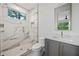 Modern bathroom features a glass-enclosed shower with marble tiling, and a vanity with a sink at 402 Chattahoochee St, Roswell, GA 30075