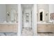 Elegant dual-sink bathroom with marble floors, wooden cabinets, and stylish mirrors at 402 Chattahoochee St, Roswell, GA 30075