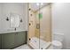 Beautiful bathroom featuring a glass shower, green vanity, and modern fixtures at 402 Chattahoochee St, Roswell, GA 30075