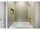 Updated bathtub with shower and niche with modern tiling at 402 Chattahoochee St, Roswell, GA 30075