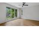Bright bedroom with large windows offering serene outdoor views and a ceiling fan at 402 Chattahoochee St, Roswell, GA 30075
