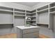 Spacious walk-in closet with custom shelving, marble countertop island, and ample storage space at 402 Chattahoochee St, Roswell, GA 30075