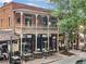 Charming two-story commercial building with outdoor seating on a brick sidewalk at 402 Chattahoochee St, Roswell, GA 30075