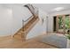 Inviting foyer with a modern staircase, wood floors, and natural light at 402 Chattahoochee St, Roswell, GA 30075