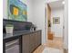Hallway features a dry bar with wine refrigerator, hardwood floors, and storage space perfect for entertaining at 402 Chattahoochee St, Roswell, GA 30075