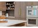 Modern kitchen with marble countertops, stainless appliances, and custom cabinetry at 402 Chattahoochee St, Roswell, GA 30075