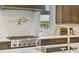 Close-up of kitchen with stainless steel range, marble backsplash, and gold accents at 402 Chattahoochee St, Roswell, GA 30075