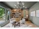 Bright living room with custom shelves, modern lighting, and beautiful backyard views at 402 Chattahoochee St, Roswell, GA 30075