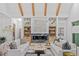 Bright living room featuring fireplace, exposed beams, built-in shelves, and hardwood floors at 402 Chattahoochee St, Roswell, GA 30075
