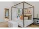 Comfortable main bedroom with a four-post bed, bright windows, and ensuite bathroom at 402 Chattahoochee St, Roswell, GA 30075