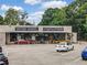 Front exterior of Historic Roswell Antiques & Interiors retail store with a parking lot and multiple parked cars at 402 Chattahoochee St, Roswell, GA 30075