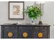 Chic sideboard features decorative accents, flowers, and a modern lamp, enhancing the room's ambiance at 402 Chattahoochee St, Roswell, GA 30075
