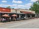 Street view showcases a row of restaurants with outdoor seating under umbrellas in a bustling town setting at 402 Chattahoochee St, Roswell, GA 30075