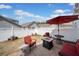 Backyard with patio furniture, an umbrella, and a neat white privacy fence creating a peaceful retreat at 510 Riverview Ln, Canton, GA 30114