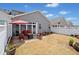 Relaxing backyard patio with outdoor seating and an umbrella, surrounded by a white fence at 510 Riverview Ln, Canton, GA 30114