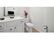 Well-lit powder room featuring a white vanity, toilet, and modern fixtures at 510 Riverview Ln, Canton, GA 30114