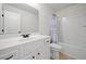 This bathroom features a tub with shower, white cabinetry, and tile floors at 510 Riverview Ln, Canton, GA 30114