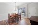 Dining room with wood table, six chairs, wood floors, modern chandelier, and natural light at 510 Riverview Ln, Canton, GA 30114
