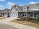 View of the charming home exterior with garage, stone accents, and sidewalk appeal at 510 Riverview Ln, Canton, GA 30114