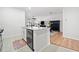 Kitchen featuring an island with granite countertops, stainless dishwasher, and open layout into the living area at 510 Riverview Ln, Canton, GA 30114