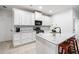 Charming kitchen featuring white cabinets, granite countertops, stainless appliances, and island with seating at 510 Riverview Ln, Canton, GA 30114