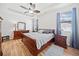 This primary bedroom features hardwood floors, natural light, and a decorative ceiling fan at 510 Riverview Ln, Canton, GA 30114
