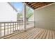 Cozy back porch overlooks backyard and features wood floors and white railing at 218 Ridley Ln, Decatur, GA 30030