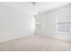 Well-lit bedroom with neutral carpeting, two windows, and fresh paint at 218 Ridley Ln, Decatur, GA 30030
