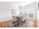 Elegant dining room with hardwood floors, a modern chandelier, and large windows that enhance natural light at 218 Ridley Ln, Decatur, GA 30030
