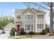 Charming two-story home with a red front door, green siding, and a well-manicured lawn and landscaped front yard at 218 Ridley Ln, Decatur, GA 30030