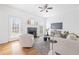 Sun-filled living room features a decorative fireplace, hardwood floors, and a comfortable seating arrangement at 218 Ridley Ln, Decatur, GA 30030
