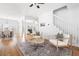 Bright and airy living space showcasing hardwood floors, an open floor plan, and a staircase to the upper level at 218 Ridley Ln, Decatur, GA 30030