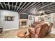 Entertaining basement with a stone fireplace, flat screen television, and an exposed rafter ceiling at 3341 Camelot Way, Loganville, GA 30052