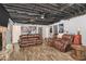 A Gathering room with stone fireplace and an exposed rafter ceiling provides plenty of room to relax at 3341 Camelot Way, Loganville, GA 30052