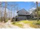 Exterior view showcasing the rear of a well-maintained home with lush greenery at 3341 Camelot Way, Loganville, GA 30052
